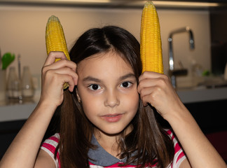 background. beautiful girl made rabbit ears by corn cob