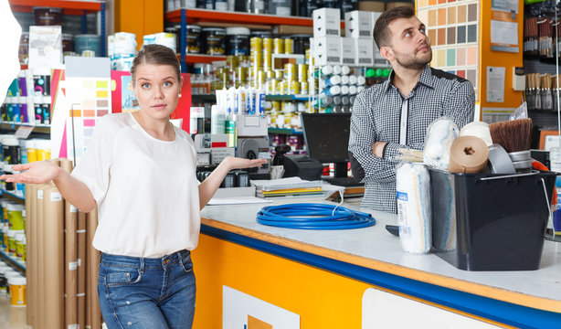 Male seller discussing  with upset girl