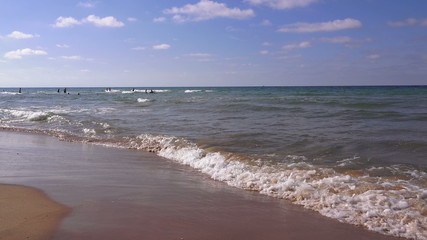 Sandy beach in summer. Transparent waves roll on a sandy beach, Turkey
