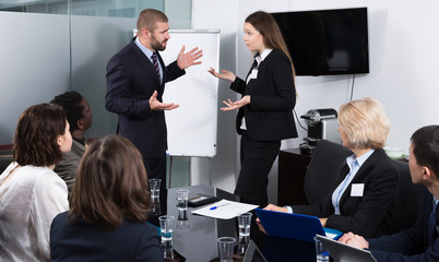 Businessman feeling angry to female coworker in office