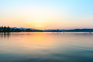 Beautiful lake and hill landscape at sunset