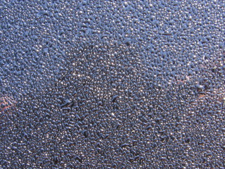Water droplets on a black surface