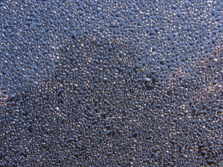 Water droplets on a black surface