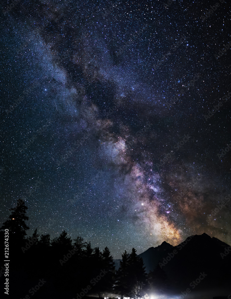 Wall mural astrophotography of milky way galaxy. silhouette of mountains. stars, nebula and stardust at night s