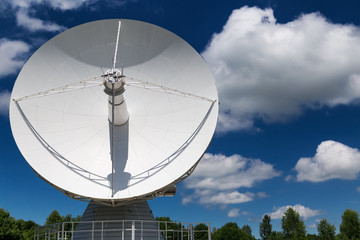 Big white radio telescope at summer day