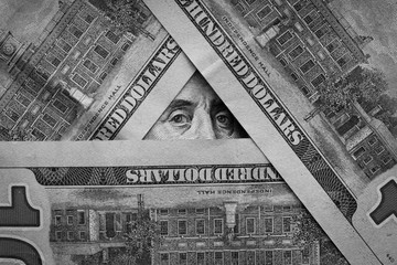 background. hundred-dollar banknotes are lined with a pyramid. Franklin.