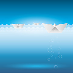 The paper-folded boat sailed on the water. Origami toys.