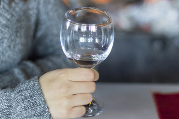 Detail shot for woman holds empty wine glass with blurry background in Izmir at Turkey for winter season