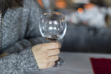 Close-up shot for woman holds empty wine glass with blurry background in Izmir at Turkey for winter season
