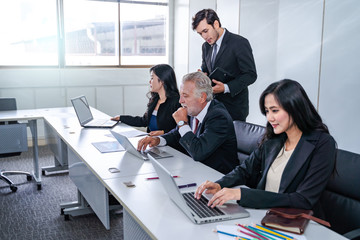 group of successful businessman. Discussion of the business profits of the company in meeting roon or conference room.