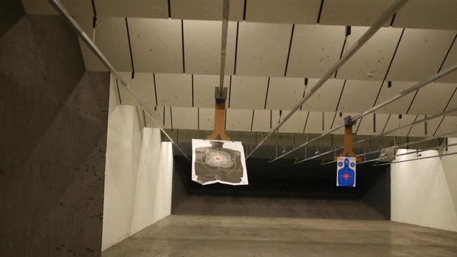 A Silhouette target at a gun range slides away from the camera 