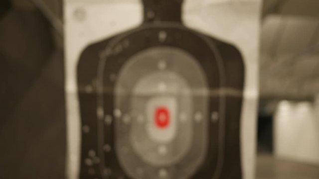 A Silhouette target at a gun range slides towards the camera - normal version