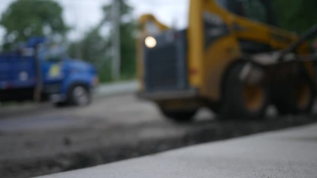 Defocused front loader near a construction project