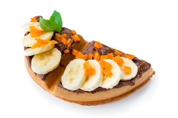 Belgium waffle with banana, chocolate paste and dried apricots isolated on white background