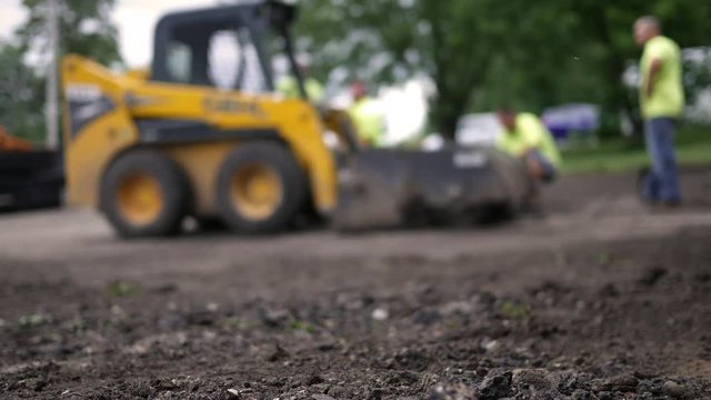 Defocused construction crew near a construction project ALT