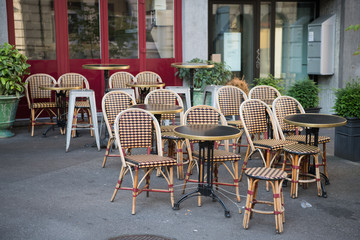 Tables and chairs in street cafe in Europe at morning after party