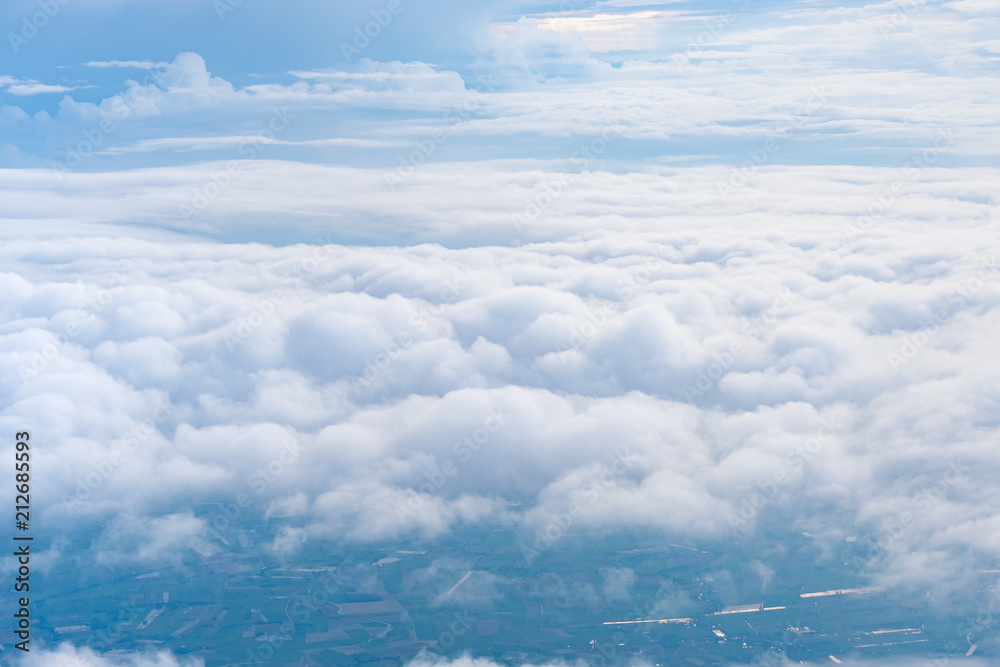 Wall mural big blue sky and cloud and city under cloud top view from airplane window,nature background.