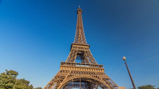 The Eiffel tower with warm light during sunset timelapse hyperlapse.