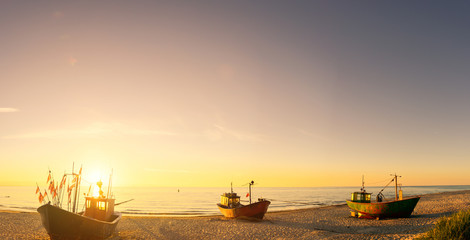 Naklejka premium fisherman boats at sunrise time on the beach