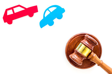 Car accident lawsuit concept. Two collided cars near judge gavel on white background top view copy...