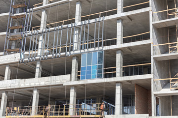 scaffolding and construction machinery on concrete building site. construction background