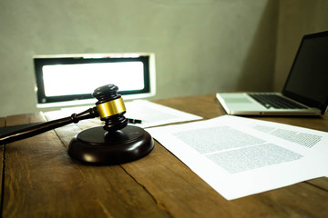 Lawyer desktop , workspace with laptop,gavel,paper and pen on the wood table.