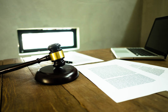 Lawyer desktop , workspace with laptop,gavel,paper and pen on the wood table. - Powered by Adobe