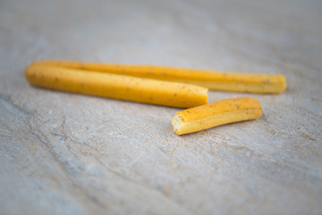 Biscuit stick on stone surface background (Selective focus)