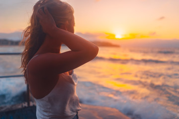 Blonde surfer girl relaxing by the beach