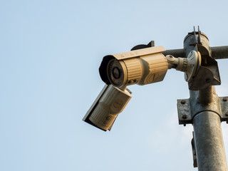 CCTV, Security Camera In The City On Blue Sky Background.