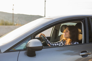 Naklejka premium woman driving a new car. Car, people concept.