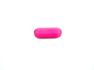 The pink pill is placed on a white background.