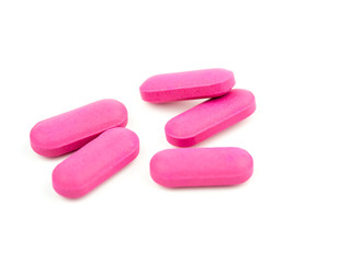 The pink pill is placed on a white background.