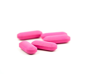 The pink pill is placed on a white background.