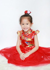 Portrait face of little asian girl in cheongsam on traditional chinese new year festival.