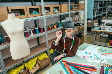 woman wearing wearing VR headset and hold a pen