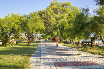 Boy walking in park near beach. Ierissos, Greece.