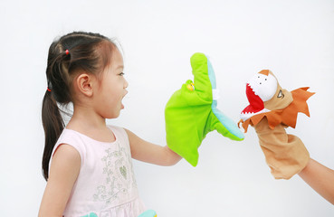 Little Asian child girl hands playing animal puppets on white background. Educations concept.
