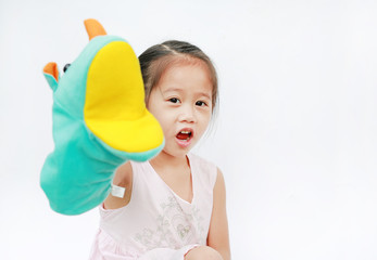 Little Asian child girl hand wear and playing Rhinoceros puppets on white background.