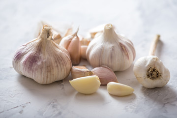 Group of garlic cloves scattered on a white background. Important ingredient in cuisines of the world. Healthy product.
