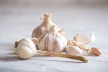 Group of garlic cloves scattered on a white background. Important ingredient in different cuisines. A healthy product.