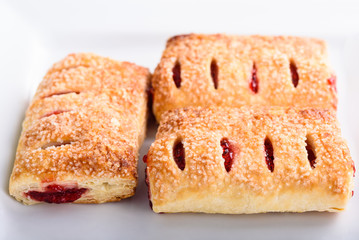 Three cherry turnovers pastries, close up view selective focus