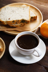 cup of black coffee with bread
