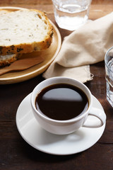 cup of black coffee with bread