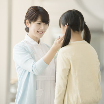 女の子と話をする看護師