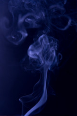 The purple clubs smoke on a black background. Fluid effect.