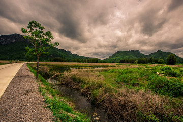 The road is surrounded by mountains. Beautiful on the go. It is a pleasure to travel one way.