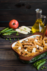 Fusilli pasta with zucchini, goat cheese and green peas