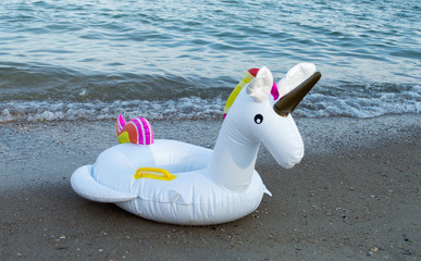  Inflatable unicorn on the beach in the background