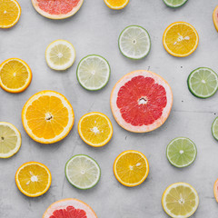 Flat lay summer background sliced citrus fruit light background